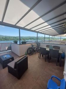 a living room with a balcony with a table and chairs at Zen Apartment in Veliko Gradište