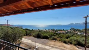a view of the ocean from the balcony of a house at Αnastasia apartments in Mavrovoúnion