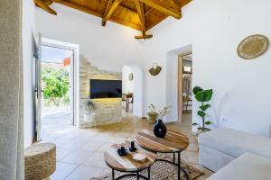 sala de estar con mesa y sofá en Villa Koukounaria, en Skopelos Town