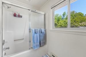 a bathroom with a shower and a window at Cloud Nine on Crystal Lake in Beulah