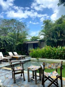 a patio with chairs and a pool and a house at Ekaa Hotel in Palomino