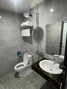 a bathroom with a sink and a toilet and a mirror at Rose hotel 