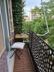 a balcony with a table and a chair on it at Piraeus open view Appartment in Piraeus
