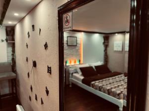 a reflection of a room with a bed in a mirror at Apartman Podroom in Kraljevo