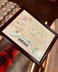 a person holding a tablet with a map on it at Apartman Podroom in Kraljevo