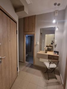 a bathroom with a desk and a mirror and a chair at Piraeus open view Appartment in Piraeus