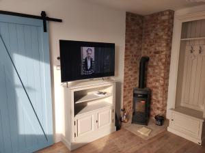 a flat screen tv on top of a white entertainment center at Apartman Šumiac 4 in Šumiac