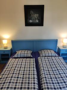 a bedroom with two beds with plaid sheets at Apartman Šumiac 4 in Šumiac