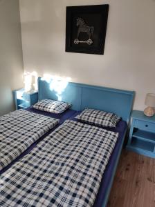 a bedroom with two beds and a picture of a horse on the wall at Apartman Šumiac 4 in Šumiac
