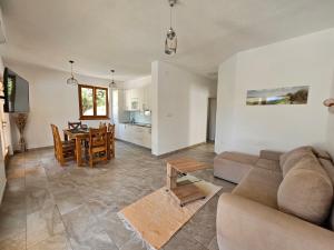 a living room with a couch and a table at Holiday homes Sintija in Rab