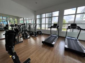 a gym with a bunch of treadms and machines in it at MAI Desaru Utama Residence in Bandar Penawar