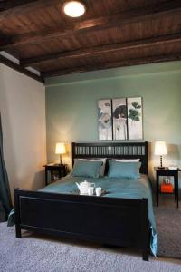 a bedroom with a bed with two lamps on two tables at Bezeniko Amazing Arcadian Property! in Vlakhérna