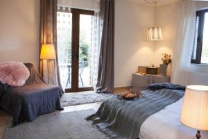 a bedroom with a large bed and a window at Bezeniko Amazing Arcadian Property! in Vlakhérna