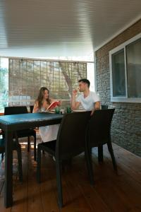 a man and a woman sitting at a table at I giardini di Santomaj in Leporano