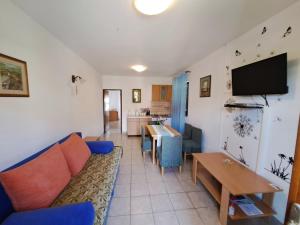 a living room with a couch and a table at Apartments 1000 Flowers in Stari Grad