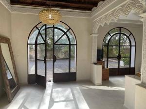 a room with two entry doors and two windows at Palast - Ruheoase Essaouira in Ouled Khellouf