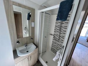 a bathroom with a sink and a shower at 3 Bedroom Caravan LG34, Lower Hyde, Shanklin in Shanklin