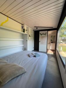 a large white bed in a room with a window at Kaasiku-Liiva Talu in Jõgela