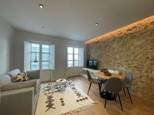 a living room with a couch and a table at housingcoruña SAN NICOLAS 27 in A Coruña