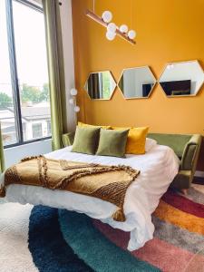 a bedroom with a bed with mirrors on the wall at Vintage Vibes - Minutes From The Broadway Buzz in Nashville