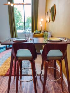 a dining room with a table and two chairs at Vintage Vibes - Minutes From The Broadway Buzz in Nashville