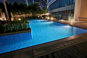a large swimming pool in a building at night at Casa Antonio At Uptown Parksuites Two in Manila