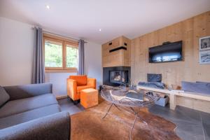 a living room with a couch and a table at Appartements Chalet Le Fornay in Morzine