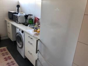 a kitchen with a counter with a washing machine at Österlen - Skillinge in Skillinge