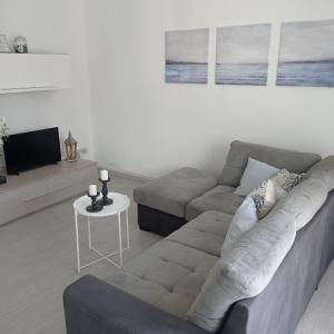 a living room with a couch and a table at Cielo Mare in Viareggio