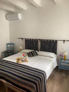 a bedroom with a large bed with a black and white blanket at Casa in pietra in antico borgo vicino al centro in Pietrasanta