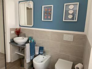 a bathroom with a sink and a toilet and a mirror at Casa in pietra in antico borgo vicino al centro in Pietrasanta