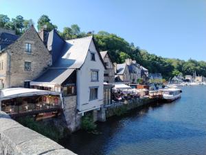 a group of buildings next to a body of water at Chambre d'hote Familiale de la maison Bleue in Lanvallay