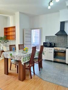 a kitchen with a table and chairs in a room at Апартаменты в центре в ЖК МАНХЕТТЕН in Almaty