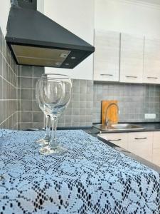 a wine glass sitting on a table in a kitchen at Апартаменты в центре в ЖК МАНХЕТТЕН in Almaty