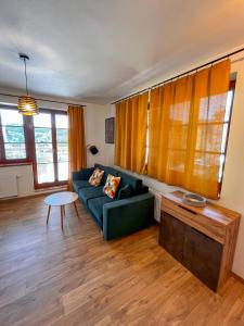 a living room with a couch and a table at Apartmán Kašperák in Kašperské Hory