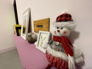 a stuffed teddy bear is on a shelf with pictures at 日月潭-讀好民宿 Read Nice House B&B in Yuchi