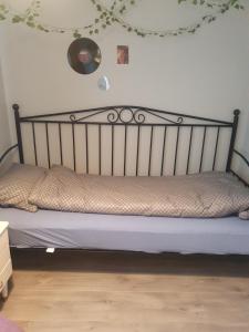 a bed with a metal headboard in a room at Apartment Kongsgård in Kristiansand