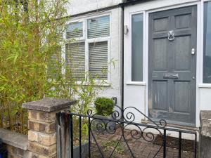 a house with a black door and a fence at Entire house floor perfect for a couple - available for single too in London