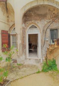 une entrée dans un bâtiment avec une fenêtre et une table dans l'établissement La maison de Toinette, à Arles