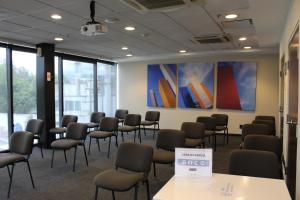 a room with chairs and a wall with a painting at Holiday Inn Express Mexico City Satelite, an IHG Hotel in Mexico City