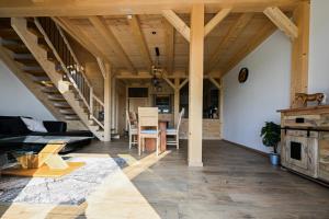 a living room with wooden ceilings and a table at Holzwies Chalets in Unterneukirchen