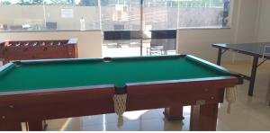 a pool table in a room with a table at The Villeneuve Residence in Caldas Novas