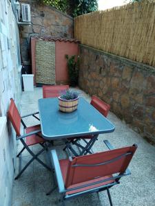 a table and chairs with a potted plant on it at Casa Sorelle Marchisio in Rome