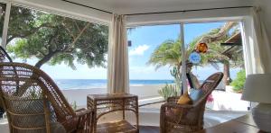 a living room with a view of the beach at Loro Verde in Playa Honda +55 photos