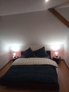 um quarto com uma cama grande e 2 candeeiros em Chez Sandra em Dalhunden