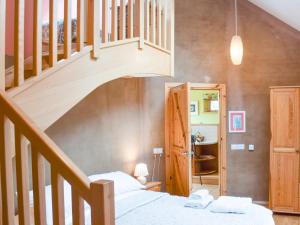 a bedroom with a bed and a staircase at Sithean in Taynuilt