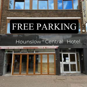 a building with a free parking sign in front of it at Hounslow Central Hotel in Hounslow