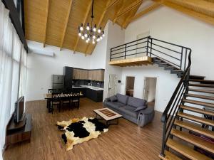 a living room with a cow laying on the floor at EMIREST Barnhouse in Gabala