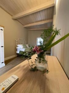 a vase with flowers on a table in a room at B&B Ai Cortili in Sant'Egidio del Monte Albino