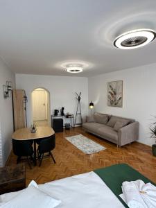 a living room with a couch and a table at My Better Place zur Lügenbrücke in Sibiu